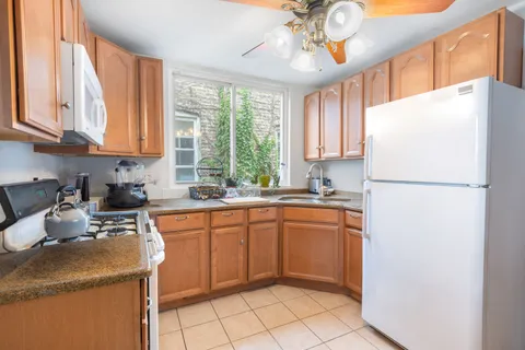 a kitchen with a refrigerator a stove a sink and a microwave