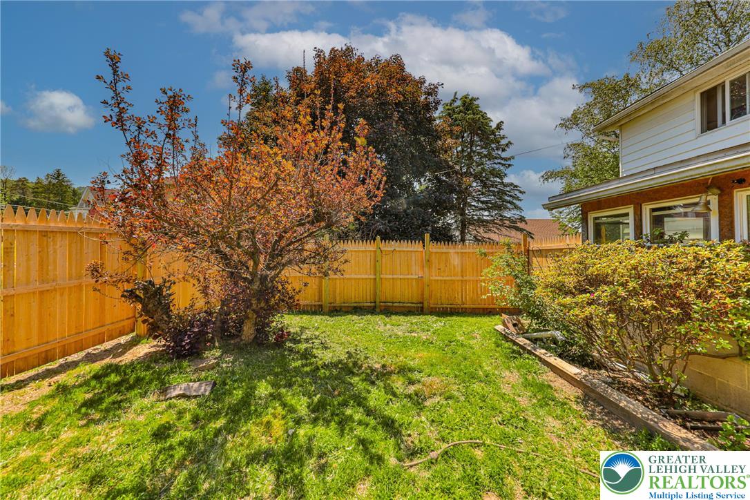 417 3rd Street Lehighton, PA 18235 - Photo 32 of 39 Fenced backyard with mature foliage offers a private outdoor haven.