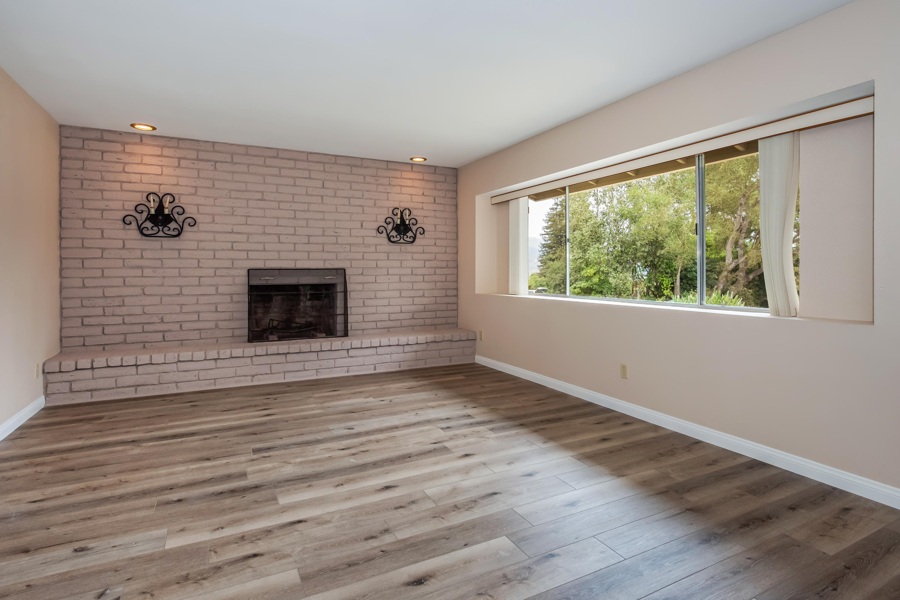 7458 Shepard Mesa Road Carpinteria, CA 93013 - Photo 4 of 17 a view of an empty room with wooden floor and a window