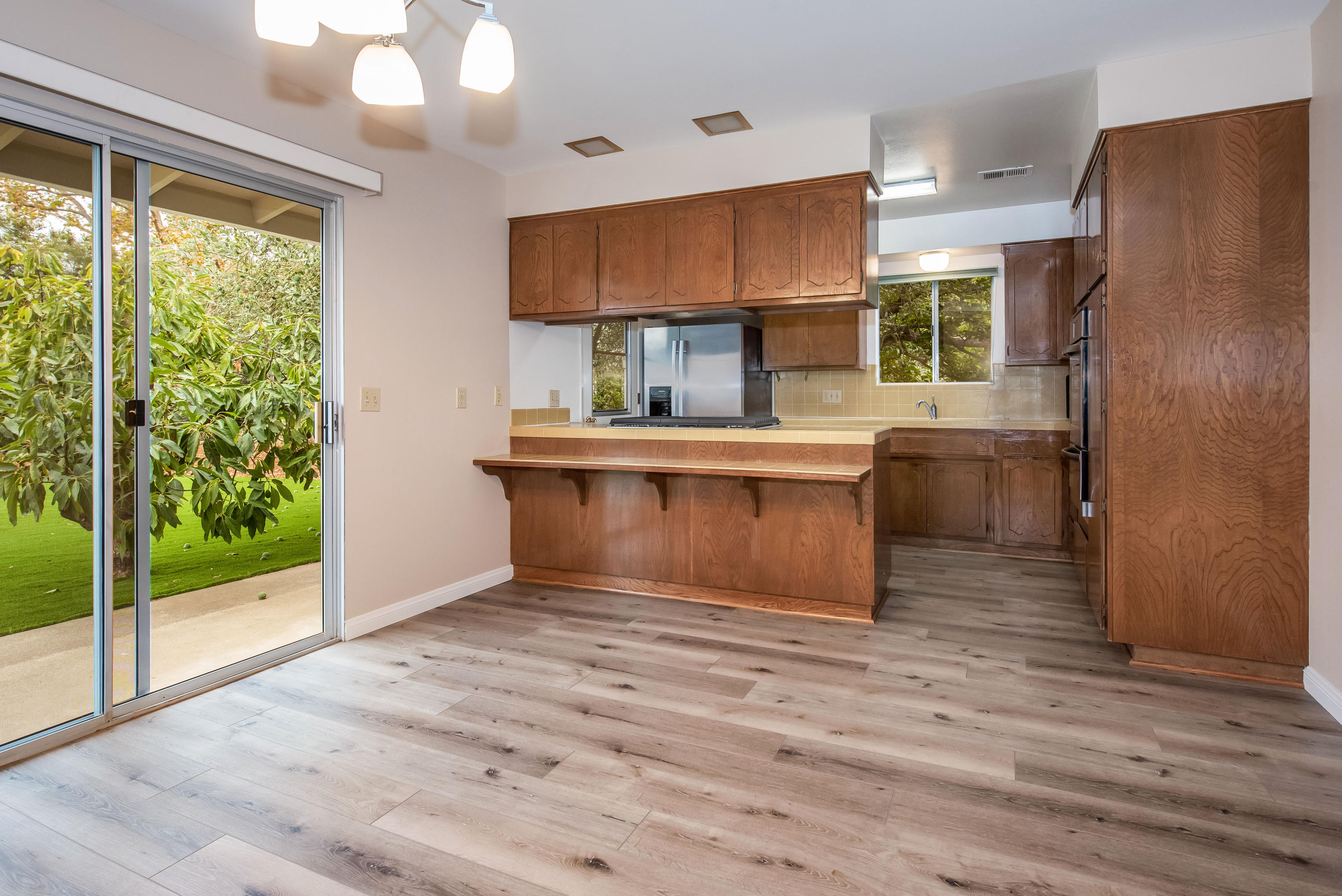 7458 Shepard Mesa Road Carpinteria, CA 93013 - Photo 6 of 17 a kitchen with kitchen island a counter top space a sink stainless steel appliances and cabinets
