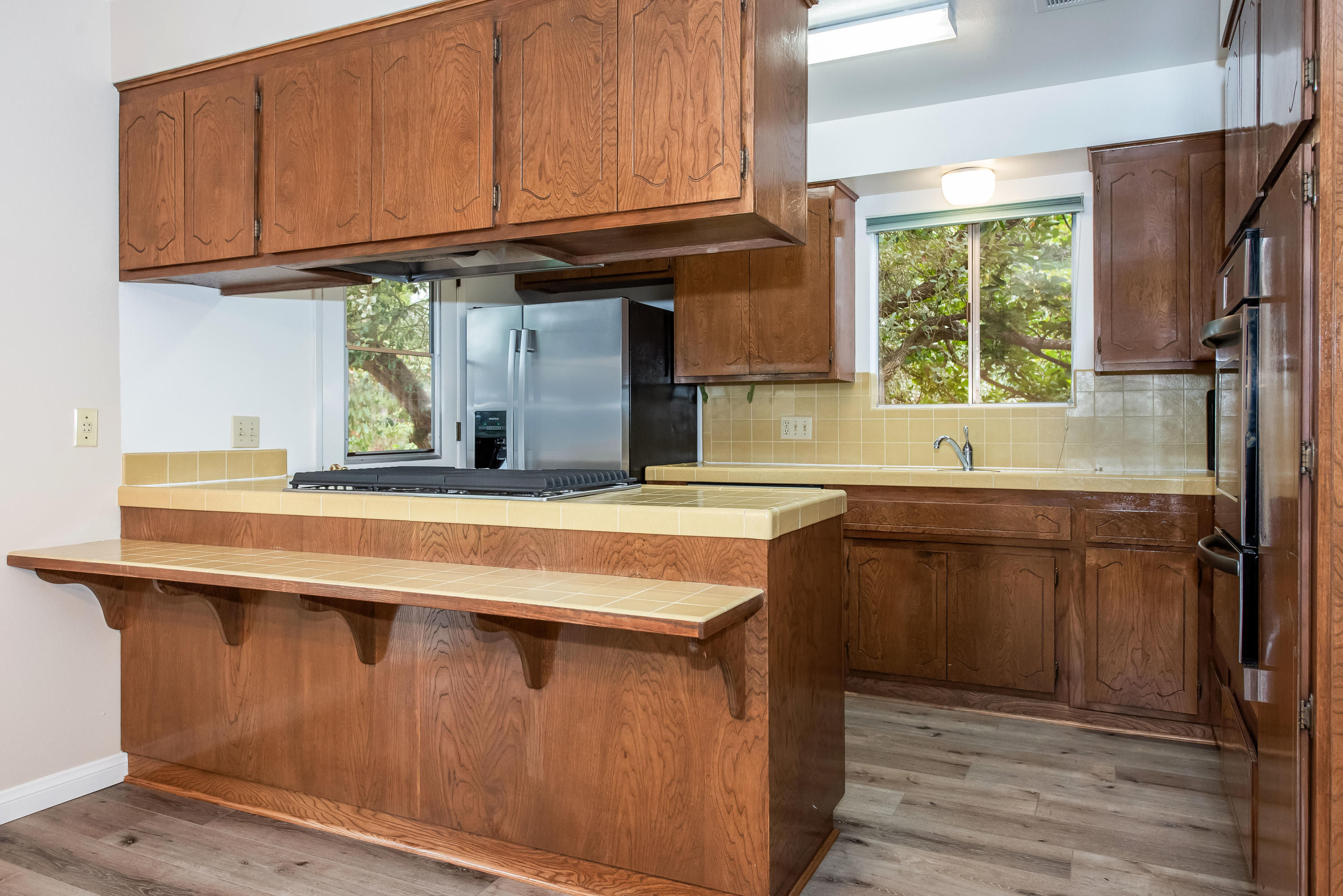 7458 Shepard Mesa Road Carpinteria, CA 93013 - Photo 7 of 17 a kitchen with stainless steel appliances granite countertop a sink a stove and a wooden floors