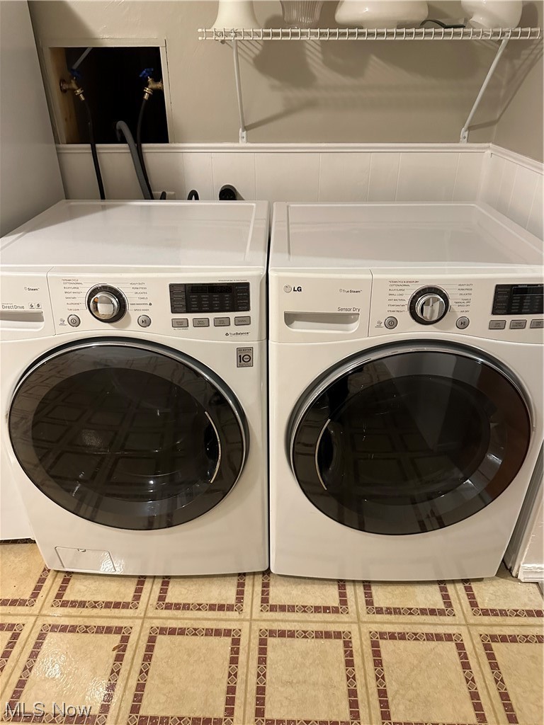 4473 Burkey Road Youngstown, OH 44515 - Photo 12 of 27 Clothes washing area with washer hookup, washing machine and dryer, and light tile floors