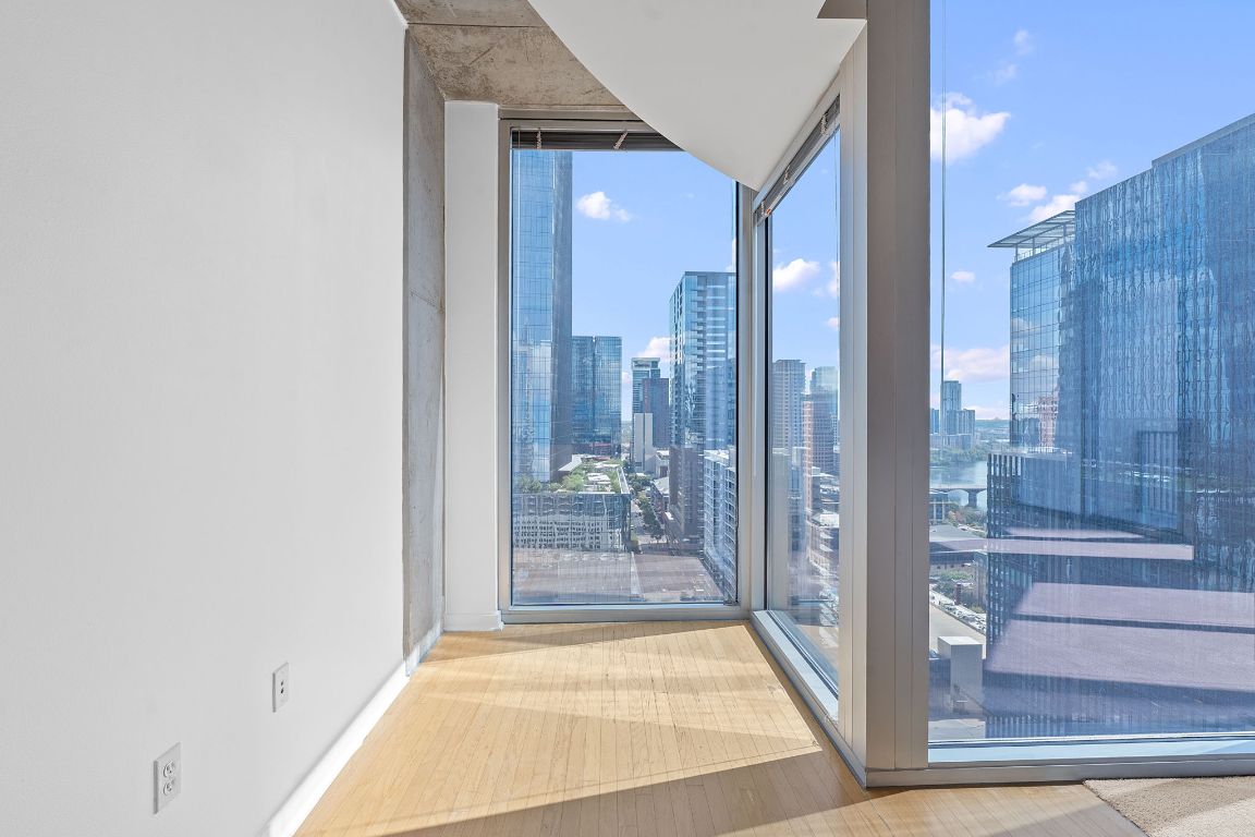 360 Nueces Street, Unit 2401 Austin, TX 78701 - Photo 16 of 40 a view of a hallway with wooden floor and a living room
