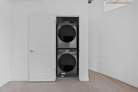 a view of a hallway with washer and dryer