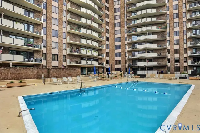 a picture of a swimming pool with outdoor seating