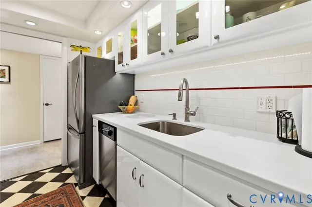 a kitchen with stainless steel appliances a sink and a refrigerator