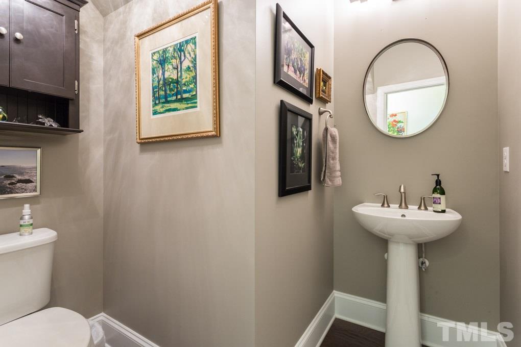 4020 Windflower Lane Raleigh, NC 27612 - Photo 14 of 29 a bathroom with a sink and a mirror