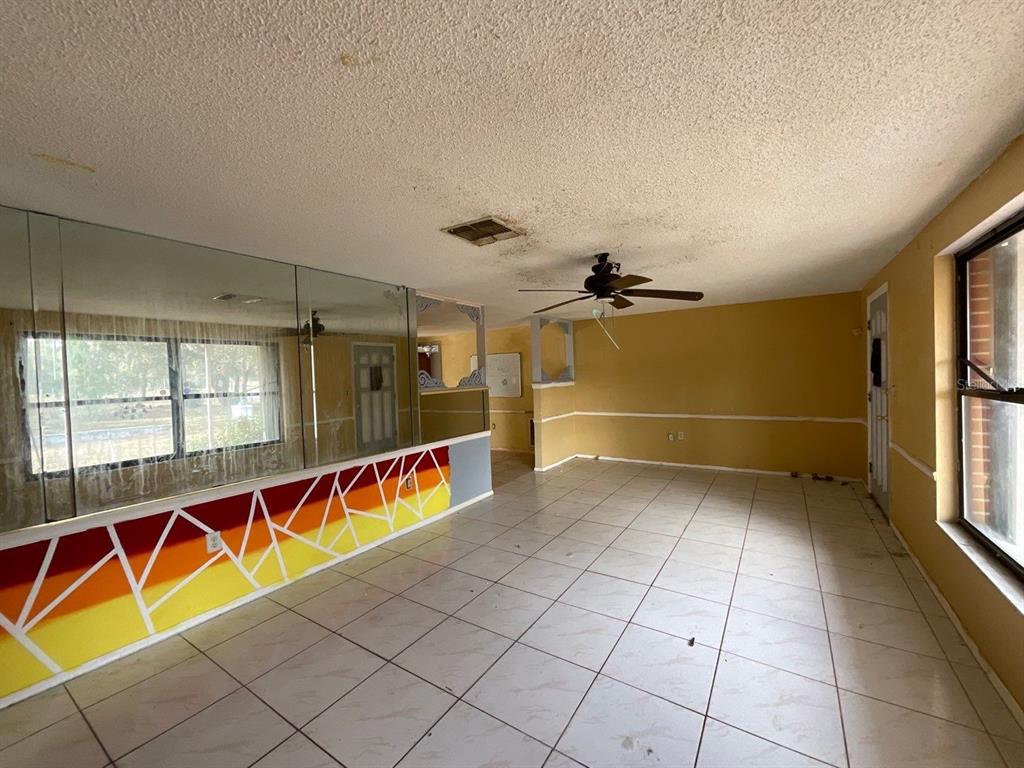 15839 Hicks Road Hudson, FL 34667 - Photo 4 of 16 an empty room with windows