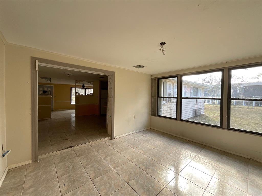 15839 Hicks Road Hudson, FL 34667 - Photo 6 of 16 a view of an empty room with a window