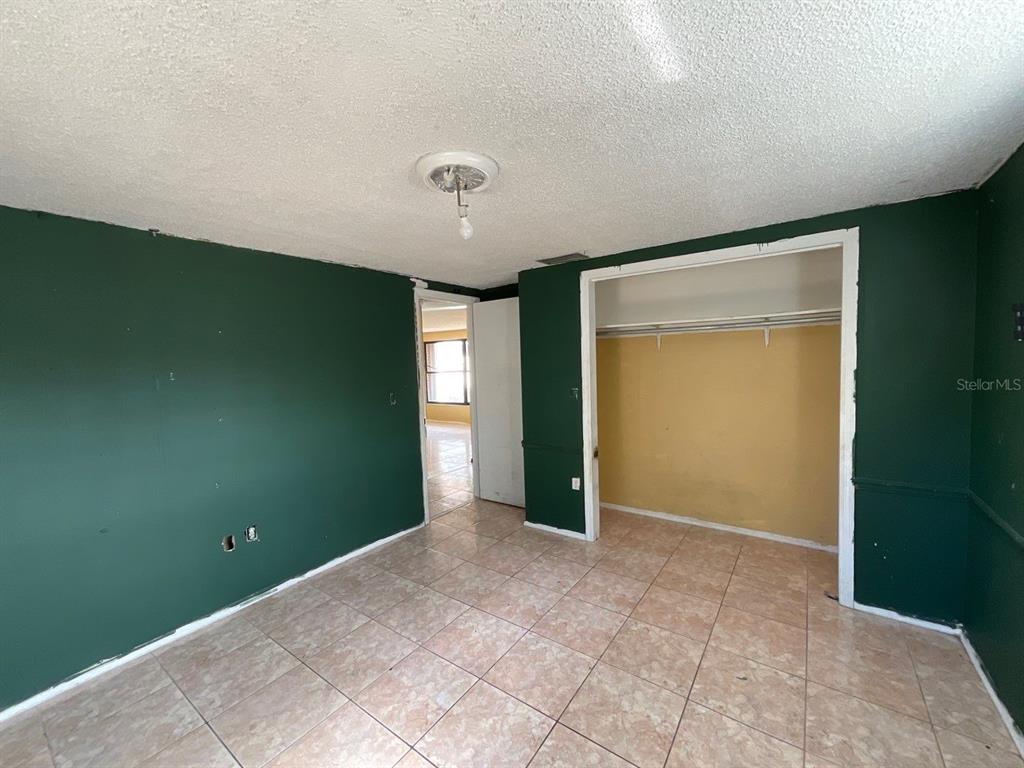 15839 Hicks Road Hudson, FL 34667 - Photo 7 of 16 a view of an empty room with closet and a window