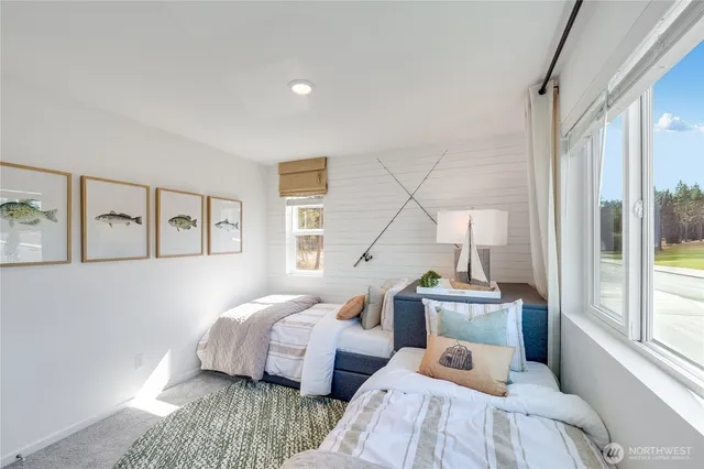 a bedroom with two beds and a large window