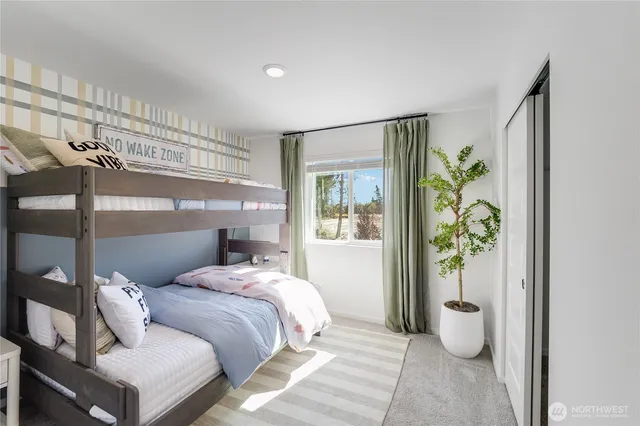 a bedroom with a bed and a painting on the wall