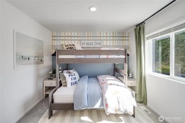 a bedroom with two beds and a window