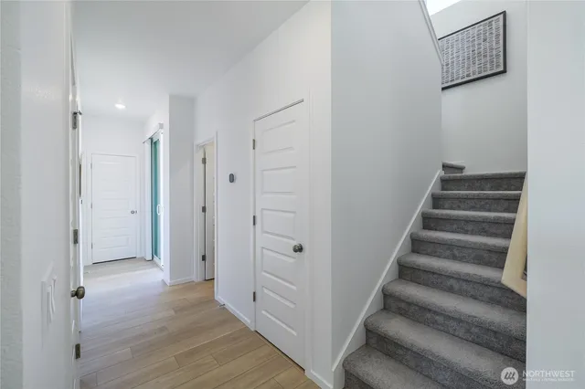 a view of an entryway with wooden floor