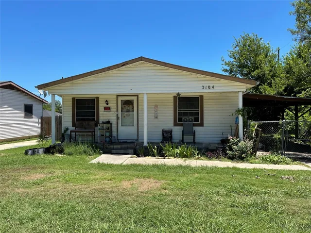 a view of house with yard and outdoor seating