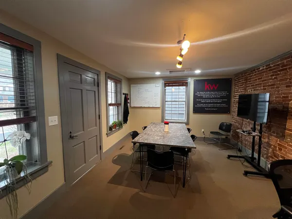 a dining room with furniture and window