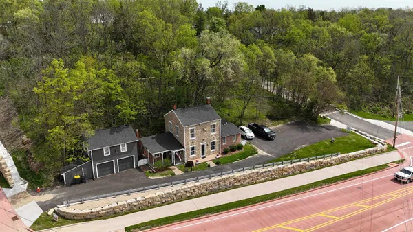 an aerial view of a house with a yard