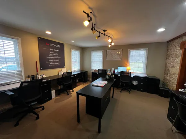 a room with furniture pool table and windows