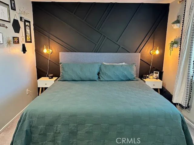 a bed room with a bed and chair