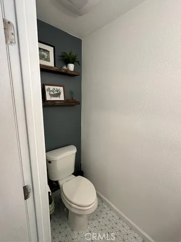 a white toilet sitting next to a shower curtain