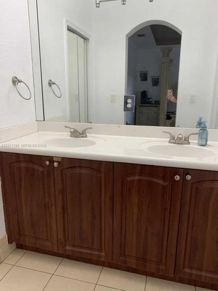 12450 Southwest 125th Terrace, Unit 12450 Miami, FL 33186 - Photo 20 of 23 a bathroom with a double vanity sink and a mirror