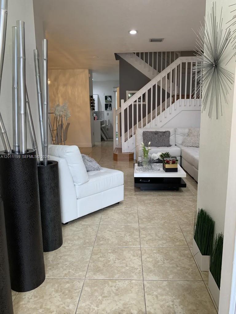 12450 Southwest 125th Terrace, Unit 12450 Miami, FL 33186 - Photo 21 of 23 a living room with furniture and a window