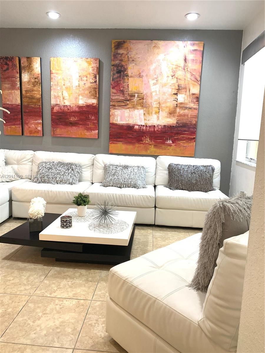 12450 Southwest 125th Terrace, Unit 12450 Miami, FL 33186 - Photo 4 of 23 a living room with furniture and a large window