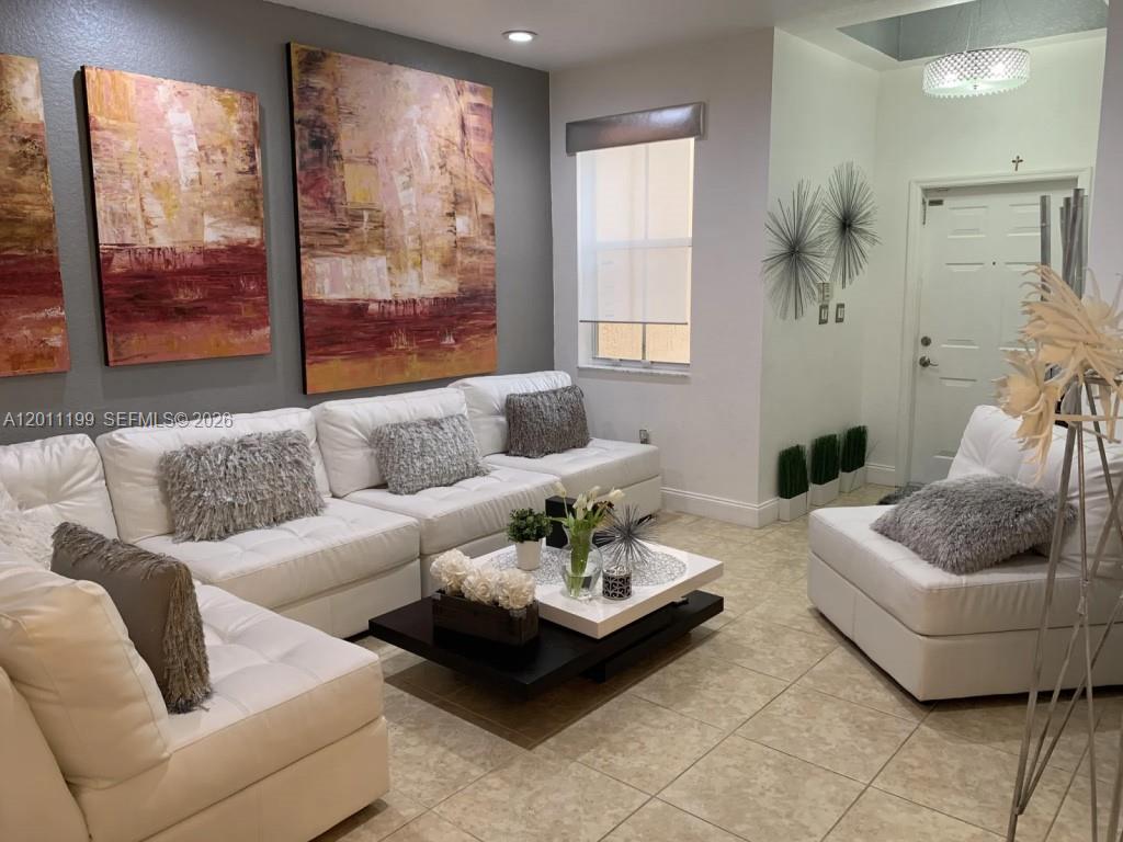 12450 Southwest 125th Terrace, Unit 12450 Miami, FL 33186 - Photo 7 of 23 a living room with furniture and a large window