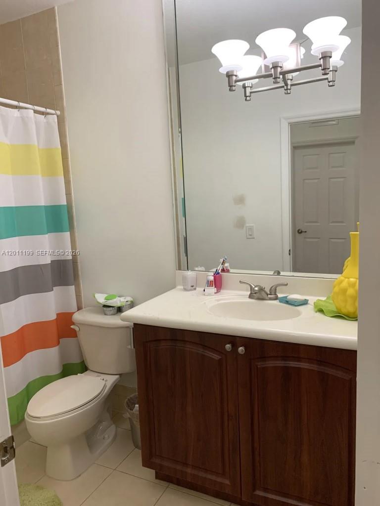 12450 Southwest 125th Terrace, Unit 12450 Miami, FL 33186 - Photo 8 of 23 a bathroom with a granite countertop bathtub sink vanity mirror and toilet
