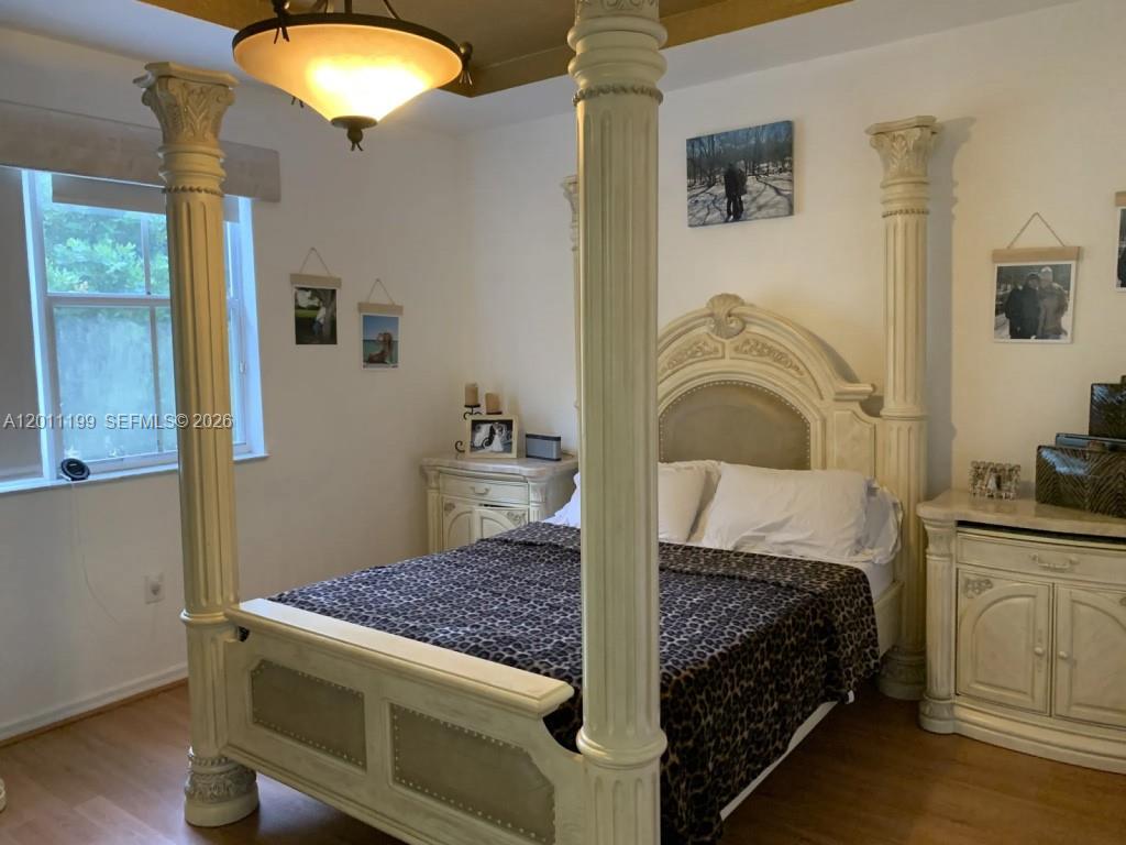 12450 Southwest 125th Terrace, Unit 12450 Miami, FL 33186 - Photo 9 of 23 a bedroom with a bed and a chandelier
