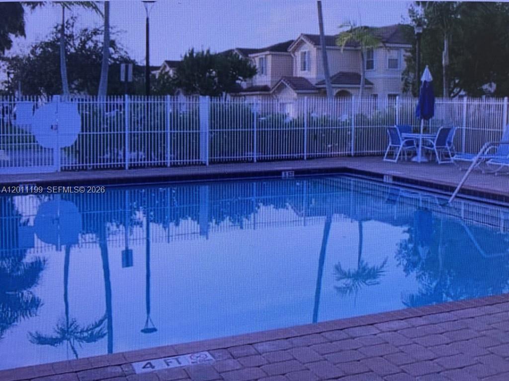 12450 Southwest 125th Terrace, Unit 12450 Miami, FL 33186 - Photo 10 of 23 a view of a room with wooden floor and a chair