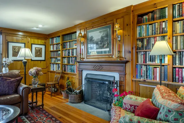 a living room with furniture fireplace and book shelf