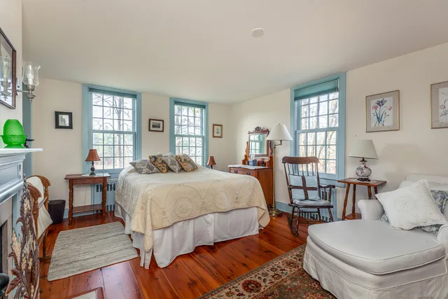 a bed room with a bed and a chair