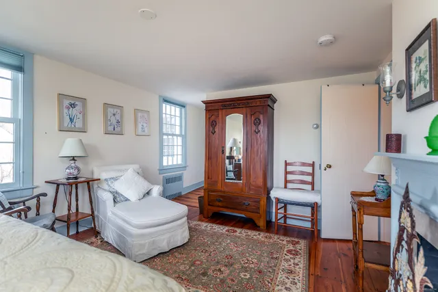 a living room with furniture and a painting on the wall
