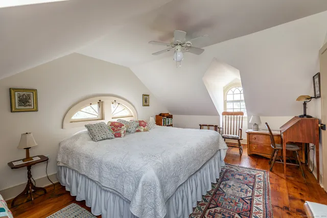 a bedroom with bed and a chandelier