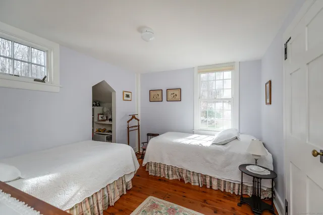 a bedroom with two beds and a window