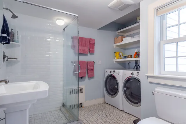 a utility room with cabinets dryer and washer