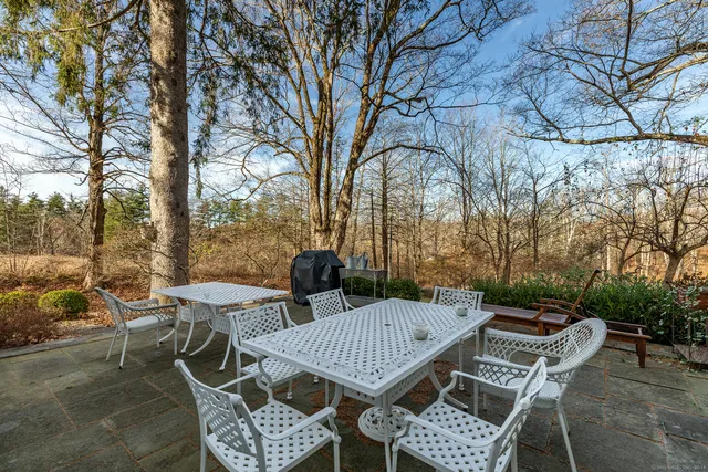 a view of a patio with table and chairs and couches