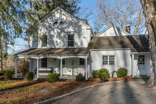 a front view of a house with yard and green space