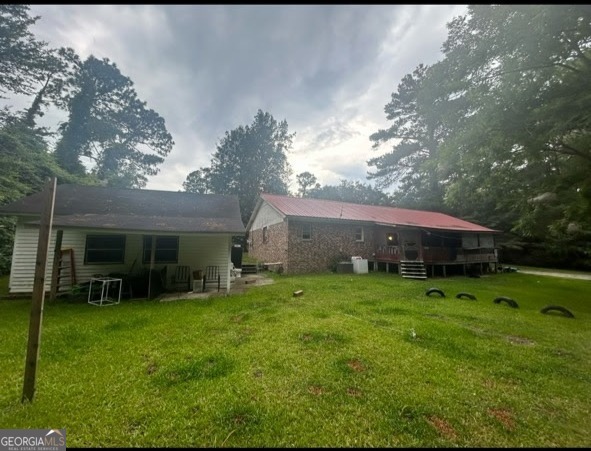 52 Brenda Road Twin City, GA 30471 - Photo 2 of 8 a view of a house with backyard and garden