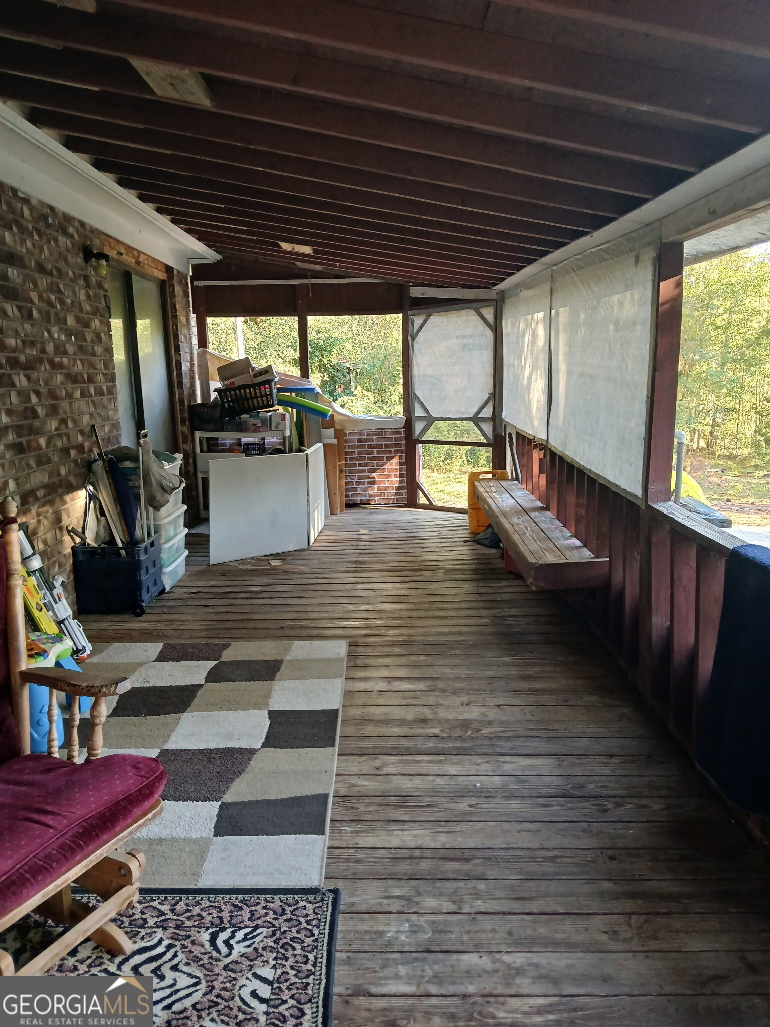 52 Brenda Road Twin City, GA 30471 - Photo 3 of 8 a view of a patio with table and chairs with wooden floor and fence