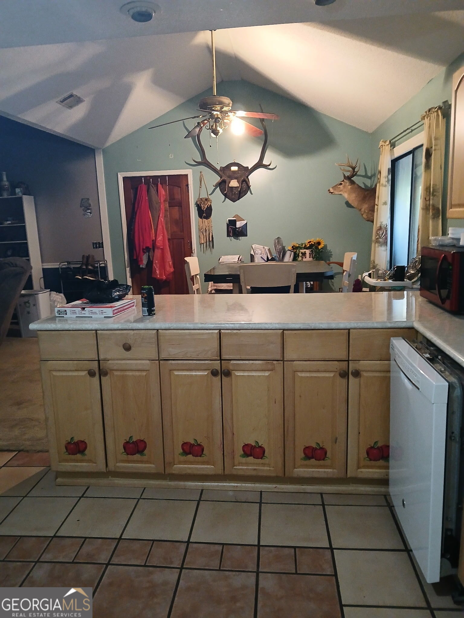 52 Brenda Road Twin City, GA 30471 - Photo 6 of 8 a kitchen with stainless steel appliances kitchen island granite countertop a sink and cabinets