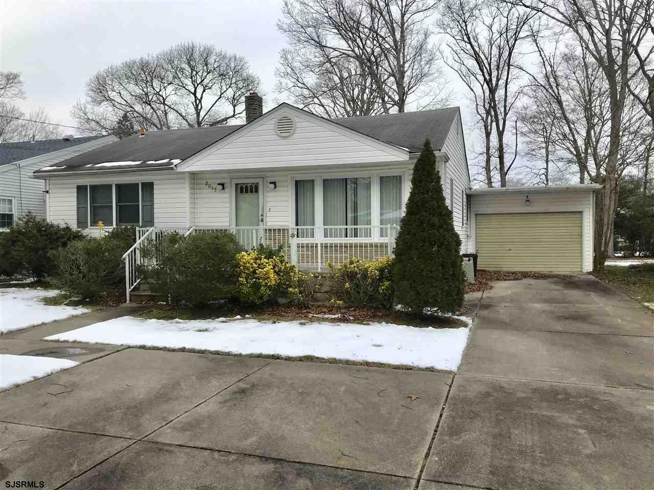 a front view of a house with yard and parking space