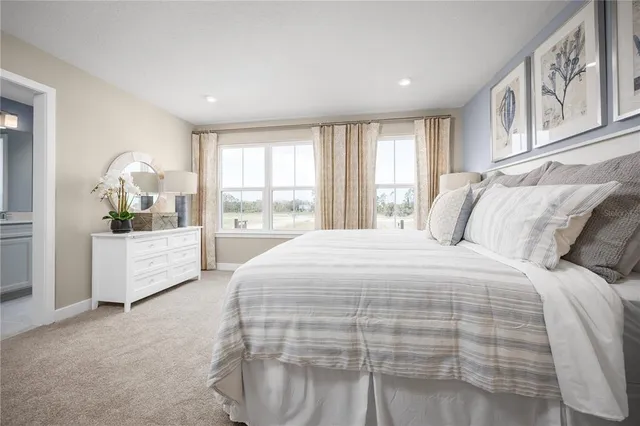 a spacious bedroom with a large bed and a window