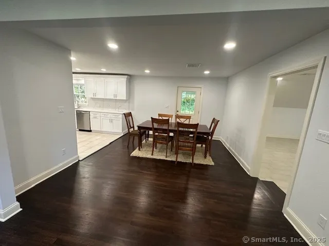 a view of a dining room with furniture wooden floor and chandelier