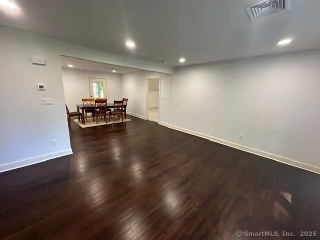 a view of a room with wooden floor and furniture