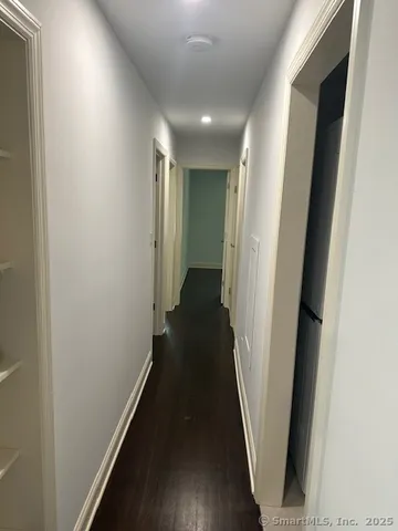 a view of a hallway with wooden floor