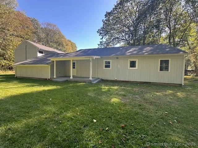 a view of a house with a backyard