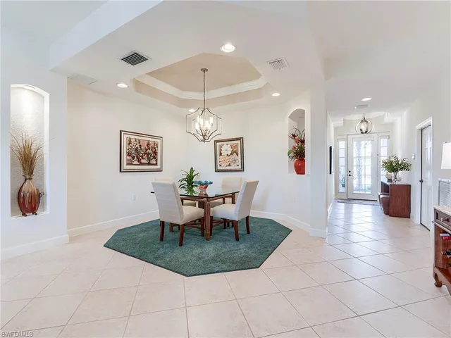 a view of a dining room with furniture and chandelier