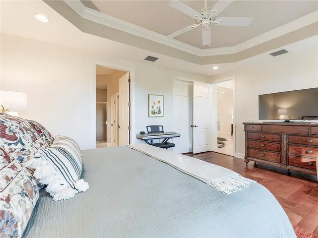 a bedroom with a bed and a flat screen tv in it